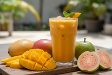 Load image into Gallery viewer, juicy mangos and guava next to a mango smoothie
