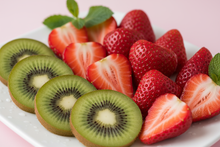 Load image into Gallery viewer, juicy strawberries and kiwi with a pink backdrop
