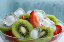 Load image into Gallery viewer, Kiwi and Strawberries sliced with ice cubes
