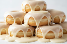Load image into Gallery viewer, White glazed donuts surrouded by gooey sugar glaze
